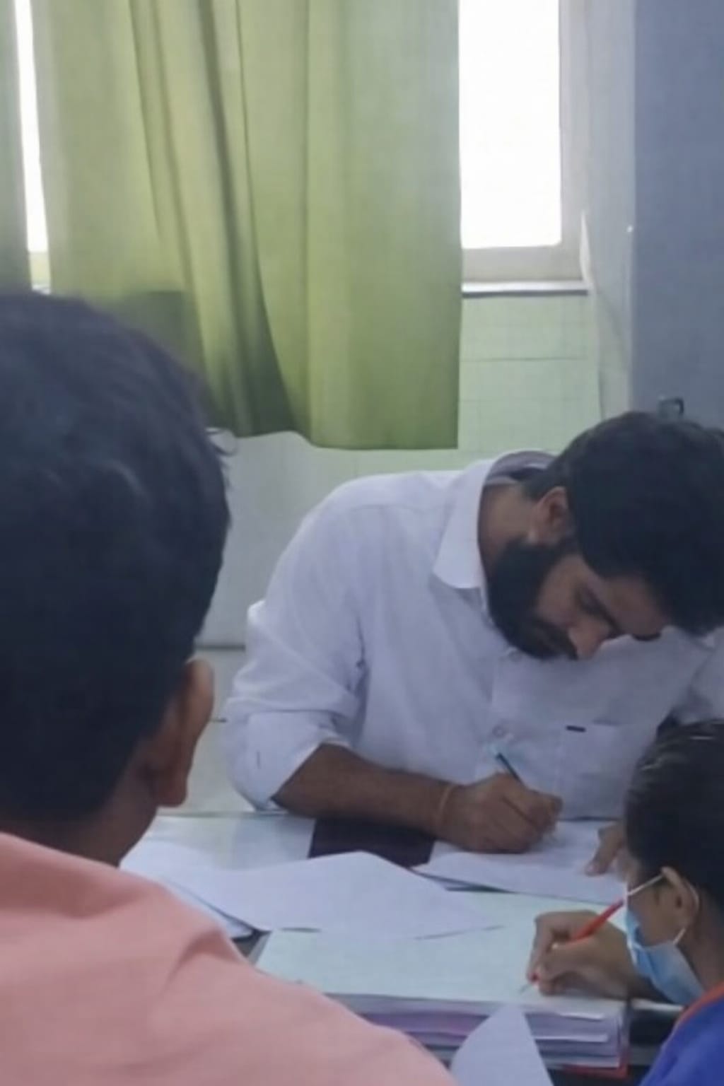 A doctor assisting visitors at an EERA health camp